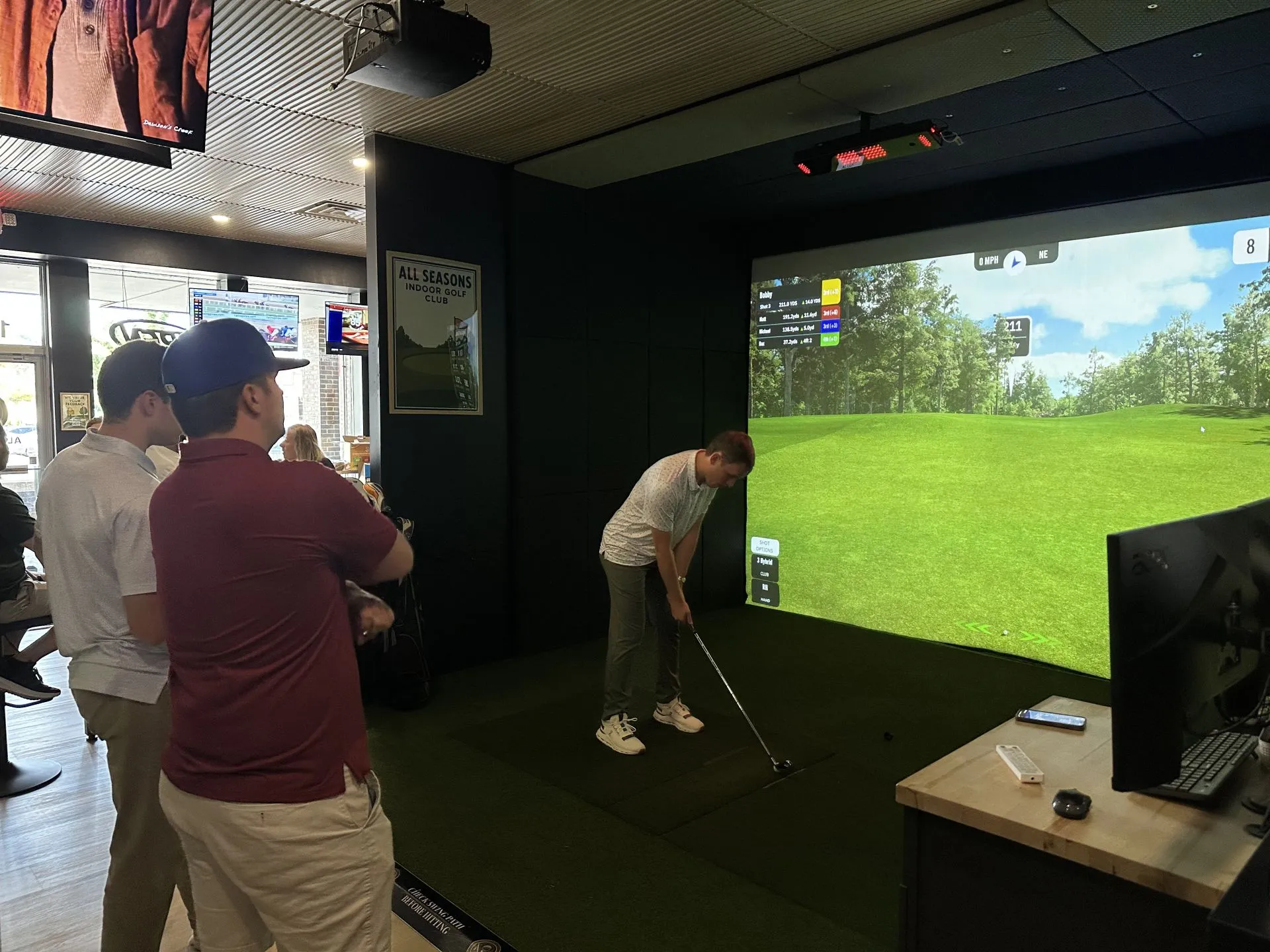 Corporate team building event with employees enjoying indoor golf at All Seasons Indoor Golf Club in Kansas City