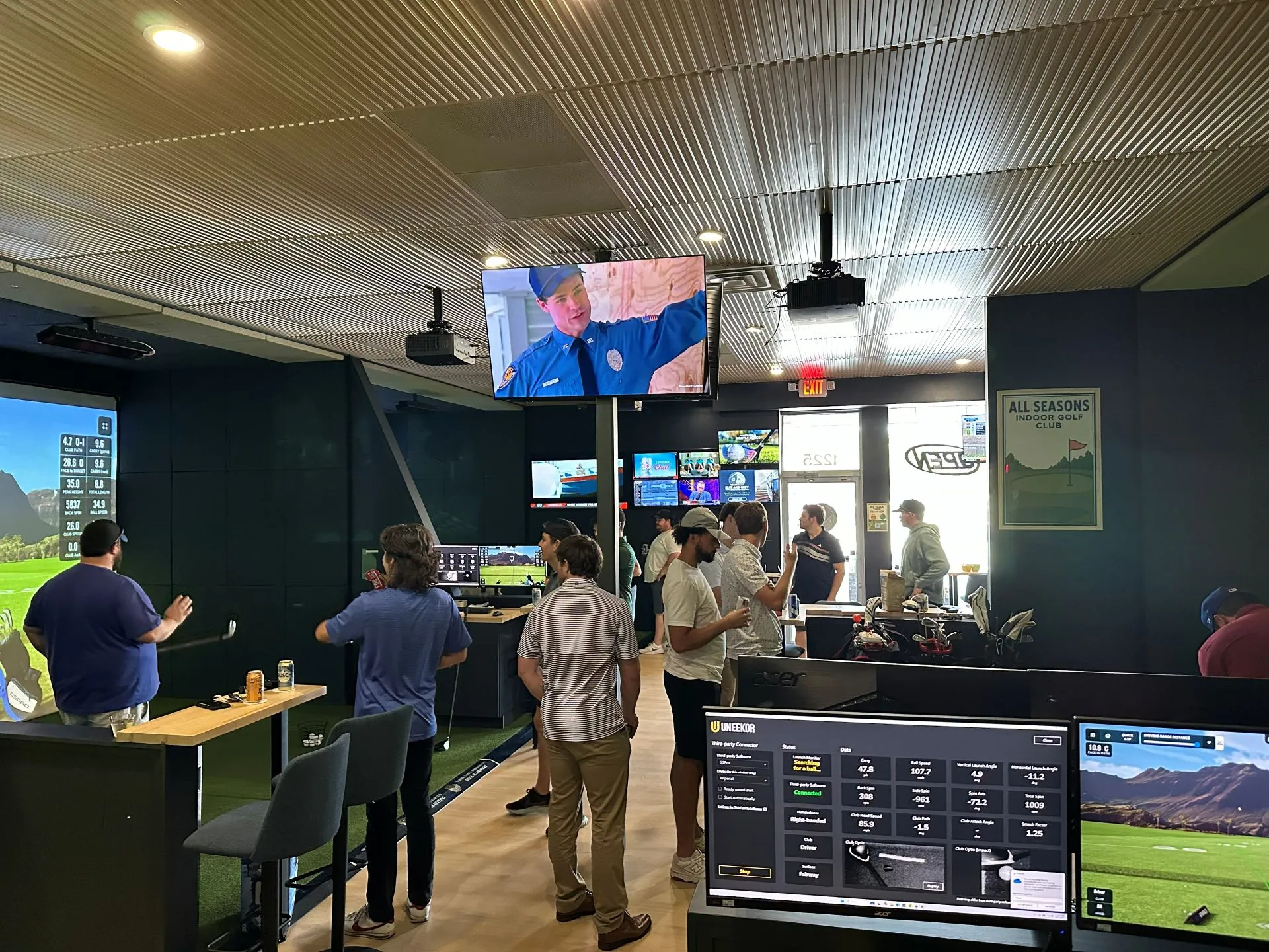 Bachelor party group celebrating with indoor golf at All Seasons Indoor Golf Club in Kansas City